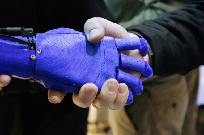 man-shakes-hands-robotic-prosthetic-hand