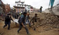 People carry the body of a victim on a stretcher, which was trapped in the debris after an earthquake hit, in Kathmandu, Nepal April 25, 2015.