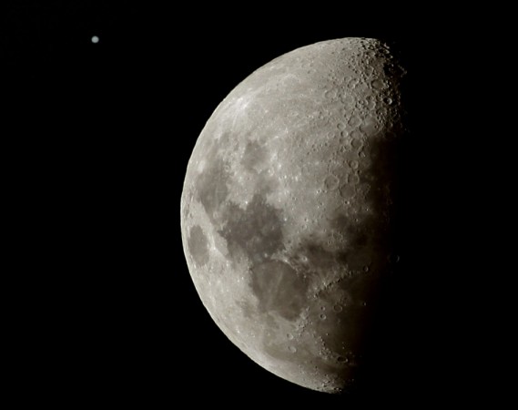 The planet Jupiter is seen next to the moon at sunset in the skies above Sydney June 16, 2005.
