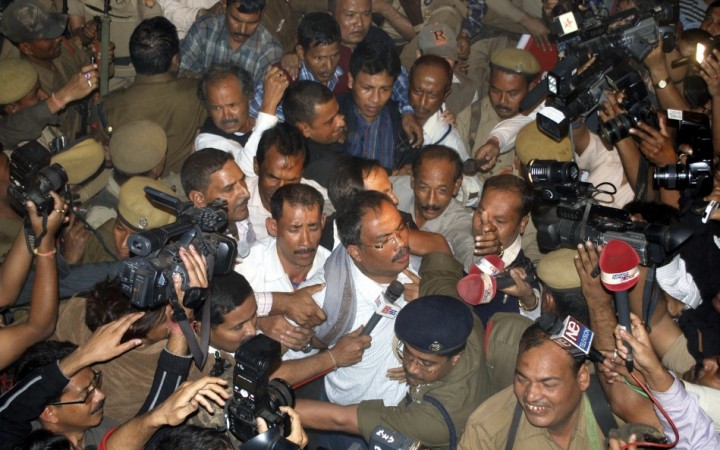 Arabinda Rajkhowa (C with spectacles), chief of the banned United Liberation Front of Assam (ULFA), is taken to court in the northeastern Indian city of Guwahati December 5, 2009. ULFA and Indian government agreement