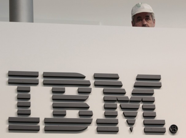 A worker is pictured behind a logo at the IBM stand on the CeBIT computer fair in Hanover February 26, 2011. A worker is pictured behind a logo at the IBM stand on the CeBIT computer fair in Hanover