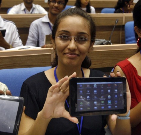 Indian students display Aakash after its launching ceremony in New Delhi. Aakash sells for $60 or $35 with government subsidies, and aims to provide tablets to the masses.