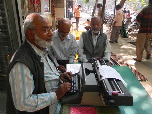 61-year-old Muneer Ahmed busy with his typewriter on a busy lane in Bangalore. Muneer Ahmed