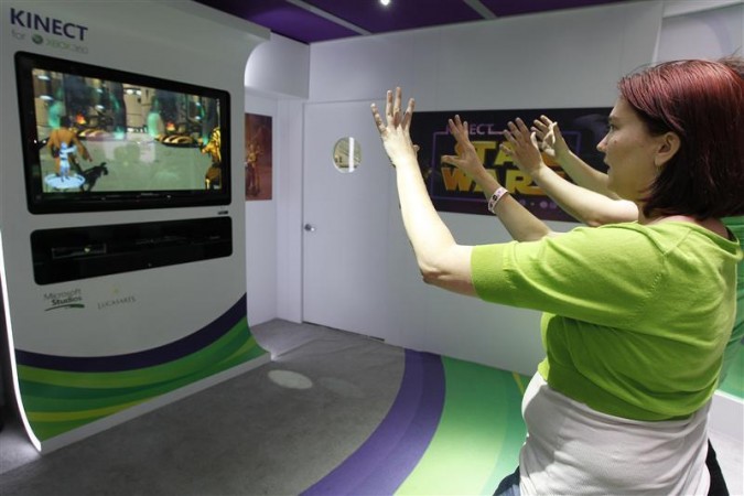 Liz Miller of Los Angeles plays Kinect for Star Wars at the Microsoft XBOX 360 booth at E3 in Los Angeles