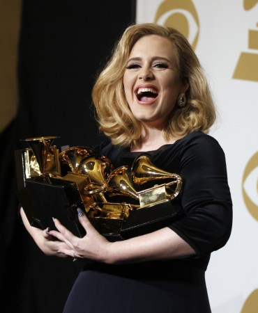 Singer Adele holds her six Grammy Awards at the 54th annual Grammy Awards in Los Angeles, California February 12, 2012. Soul singer Adele triumphed in her return to music's stage on Sunday, scooping up six Grammys and winning every category in which she was nominated including album of the year for Adele