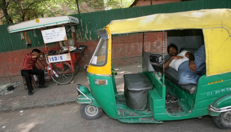 An auto-rickshaw driver taking a nap