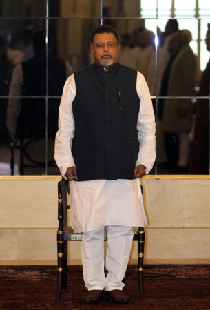 India's Railways Minister Mukul Roy stands to attention as the national anthem is played during the oath taking ceremony at the presidential place in New Delhi March 20, 2012. Mukul Roy