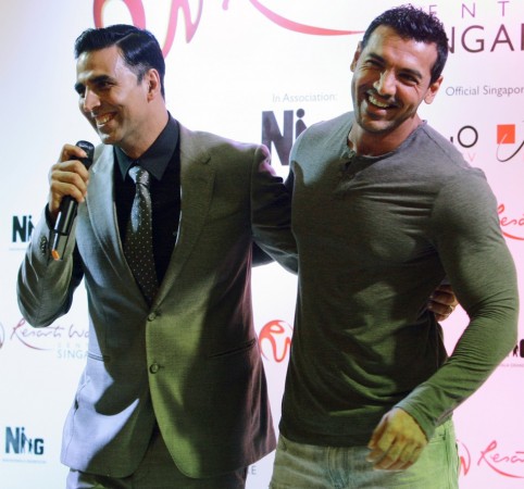 Bollywood actors John Abraham (R) and Akshay Kumar share a light moment at the world premiere of 'Housefull 2' Singapore Premier