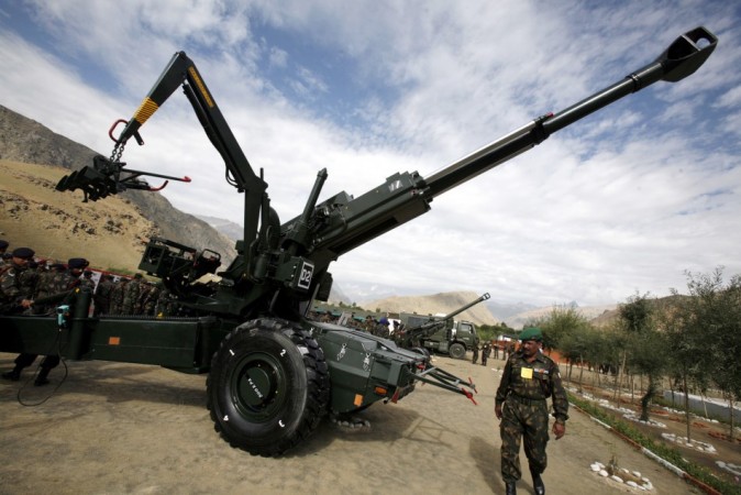 Indian army soldier walks past a Sweden made 155 mm Bofors artillery gun during Indian army