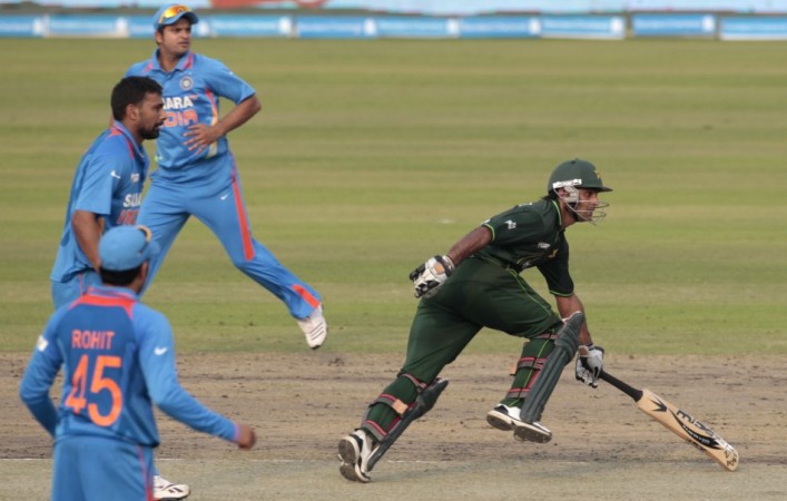 Pakistan's Mohammad Hafeez runs between the wickets as India's players watch during their One Day International (ODI) cricket match of Asia Cup in Dhaka.