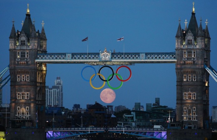 The full moon rises through the Olympic Rings hanging beneath Tower Bridge during the London 2012 Olympic Games August 3, 2012. REUTERS/Luke MacGregor Sixth Olympic ring