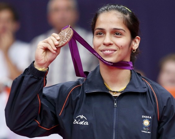 India's Saina Nehwal holds up her bronze medal at the women's singles badminton victory ceremony at the London 2012 Olympic Games at the Wembley Arena. India's Saina Nehwal holds up her bronze medal at the women's singles badminton victory ceremony at the London 2012 Olympic Games at the Wembley Arena.