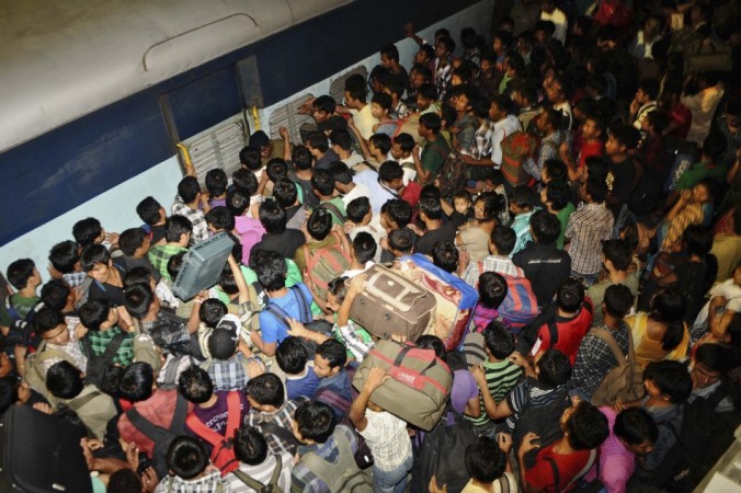 People from India's northeastern states crowd to board a train back to their homes at the railway station in the southern Indian city of Bangalore Plight of terrorised North-East Indians in pictures