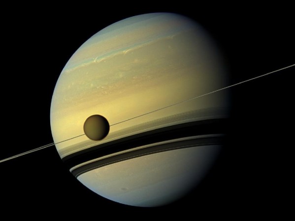 This image shows a natural color view of Saturn and its biggest moon Titan from NASA's Cassini spacecraft. Saturn And Titan