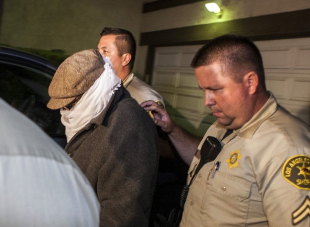 Nakoula Basseley Nakoula is escorted out of his home by Los Angeles County Sheriff's officers in Cerritos, California