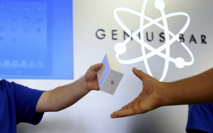 An Apple employee hands out an iPhone 5 at an Apple Store in San Francisco
