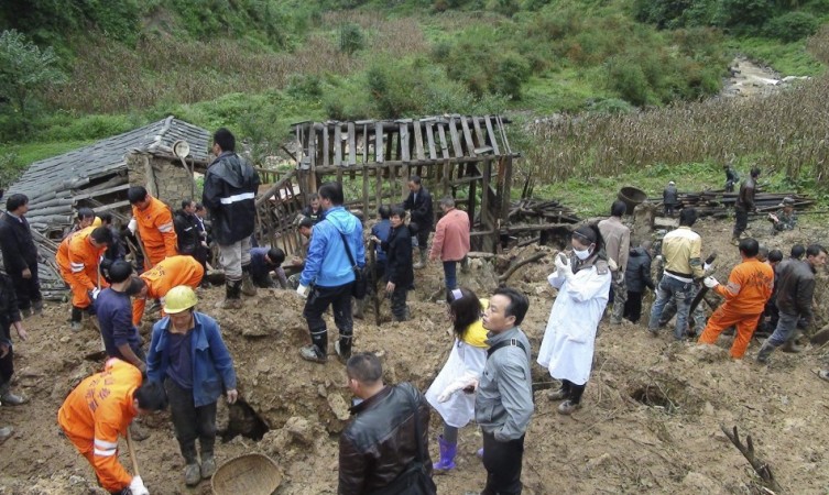 Rescuers search for victims after a landslide engulfed a building of a primary school at Zhenhe village of Yiliang county China Landslide