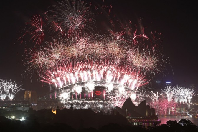 Fireworks explode around the Sydney Harbour Bridge and Sydney Opera House last year Sydney New Year's Eve
