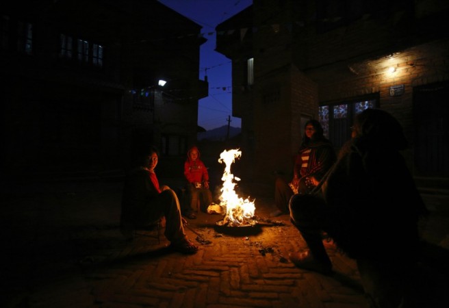 A family sits near the fire outside their house to keep warm on a cold evening at Kathmandu January 1, 2013. REUTERS/Navesh Chitrakar Cold wave in north India