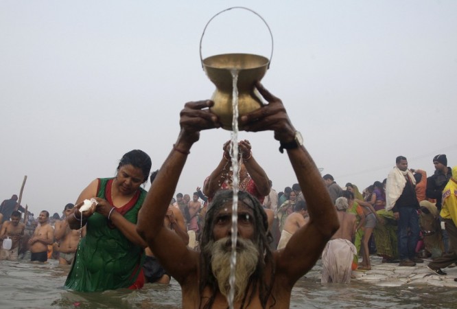 Hindu devotees pray as they attend the first Kumbh Mela