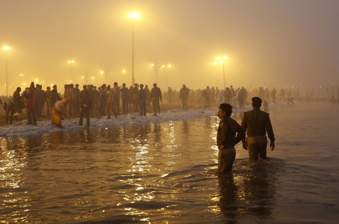 Policemen stand in waters of Ganges river to maintain order during first Kumbh Mela