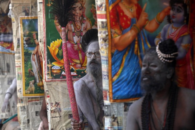Naga Sadhus or Hindu holymen sit under their temporary shelters Naga Sadhus