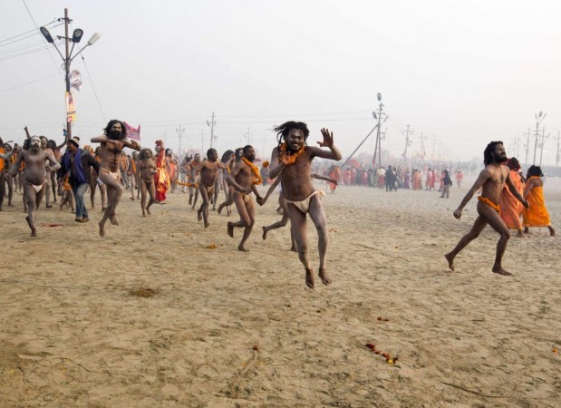 Naga sadhus, or Hindu holymen, run to attend the first 'Shahi Snan' (grand bath) at the ongoing Naga Sadhu