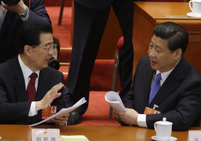 Photographers take pictures of China's President Hu Jintao as he talks to China's Communist Party Chief Xi Jinping during the opening ceremony of the National People's Congress (NPC) at the Great Hall of the People China's National People's Congress