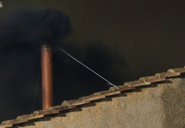 Black smoke rises from the chimney on the roof of the Sistine Chapel in the Vatican City indicating that no decision has been made after the first day of voting for the election of a new pope Black Smoke