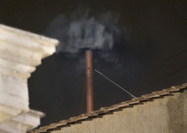 Black smoke rises from the chimney on the roof of the Sistine Chapel in the Vatican City indicating that no decision has been made after the first day of voting for the election of a new pope Black smoke