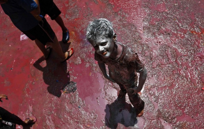 A boy smeared with colour poses for a picture during Holi celebrations in the southern Indian city of Chennai Holi 2013