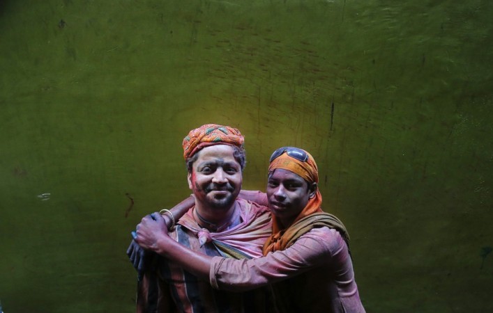 Two Hindu devotees pose for a picture during Holi celebrations in a lane near the Bankey Bihari temple in Vrindavan Holi 2013