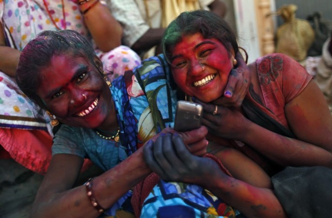 Two girls share a moment as they sit outside the Bankey Bihari temple after celebrating Holi in Vrindavan Holi 2013