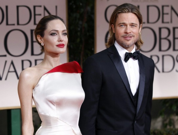 File photo of actors Angelina Jolie and Brad Pitt posing for photographers as they arrive at the 69th annual Golden Globe Awards in Beverly Hills Angelina Jolie and Brad Pitt