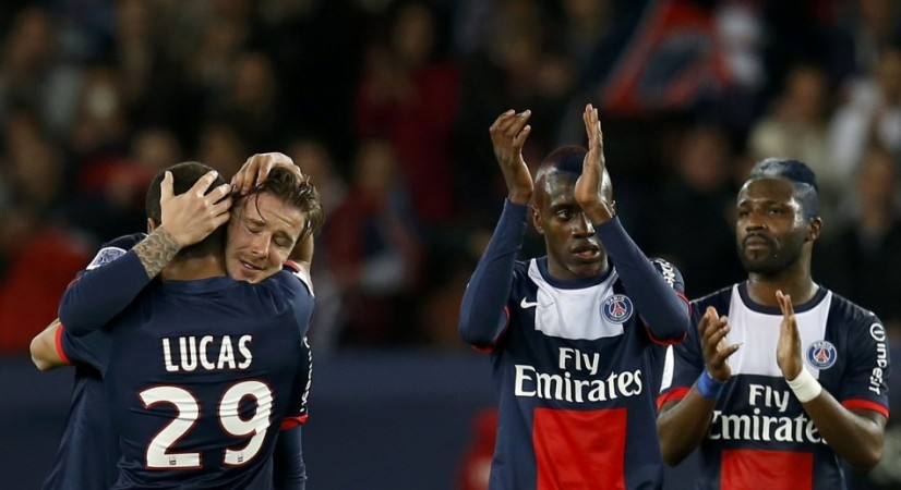 Paris Saint-Germain's Beckham hugs team mates at the end of his team's French Ligue 1 soccer match against Brest at the Parc des Princes stadium in Paris David Beckham
