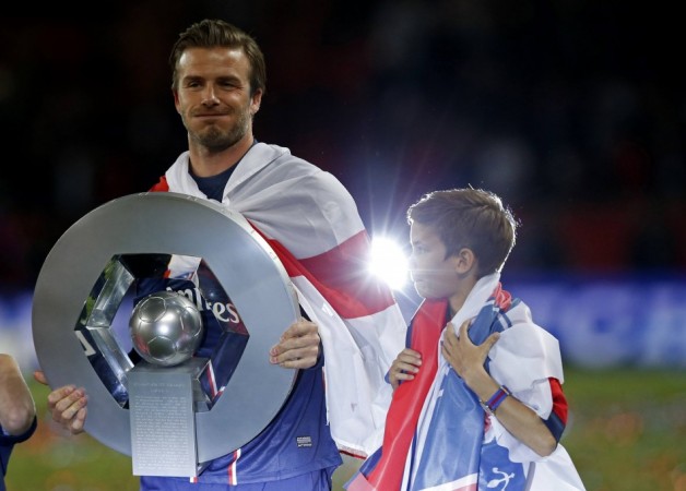 Paris Saint-Germain Beckham raises the French Championship trophy at the end of their team's French Ligue 1 soccer match against Brest at the Parc des Princes stadium in Paris David Beckham