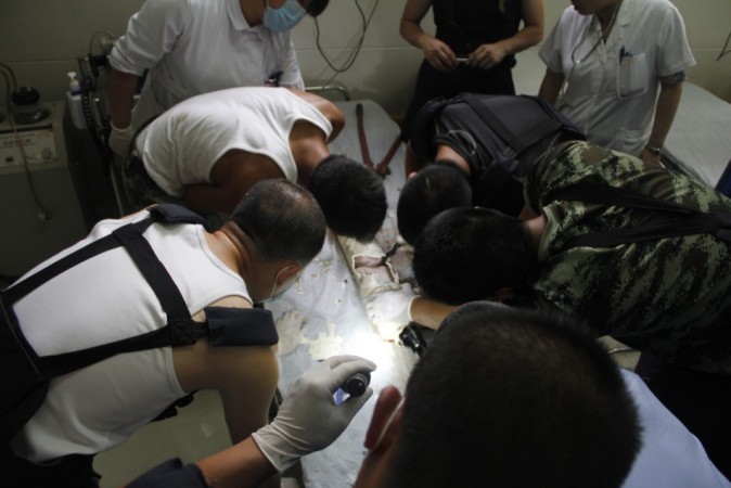 Firefighters and doctors rescue an abandoned newborn baby boy by cutting away a sewage pipe piece by piece, in this still image taken from video, in Jinhua city, Zhejiang province May 25, 2013 (Reuters) Chinese newborn baby
