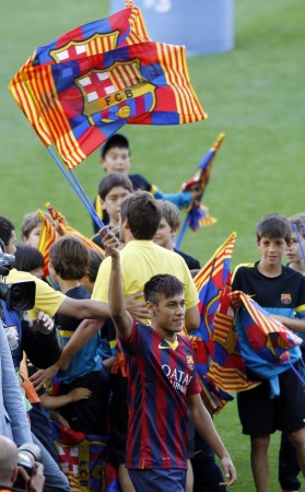 Neymar waves to Barcelona's supporters at his presentation after signing a five-year contract with the club, at Nou Camp stadium in Barcelon Neymar