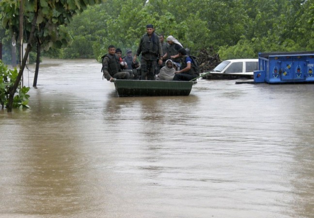 Indian army soldiers rescue stranded villagers in a boat after floods triggered by heavy rains(Reuters)