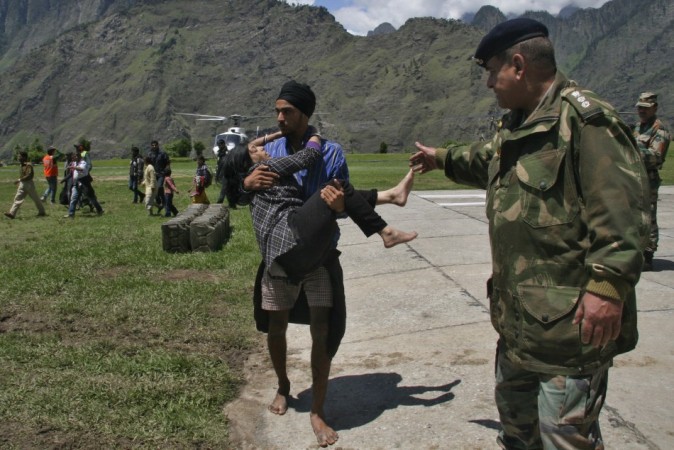 A man carries a flood affected victim after they were rescued by the Indian army after heavy rains in the Himalayan state of Uttarakhand June 19, 2013. (Reuters) North India Floods