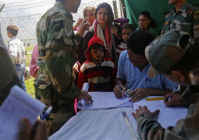 A boy has his details noted by soldiers after getting off from an army helicopter with other survivors at Joshimath in the Himalayan state of Uttarakhand June 21, 2013. (Reuters) North India Floods