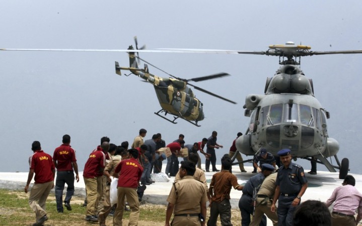 Handout of personnel from the Indian armed forces carrying relief supplies from a helicopter for stranded people at Guptkashi after heavy rains in the Himalayan state of Uttarakhand (Reuters) Handout of personnel from the Indian armed forces carrying relief supplies from a helicopter for stranded people at Guptkashi after heavy rains in the Himalayan state of Uttarakhand (Reuters)