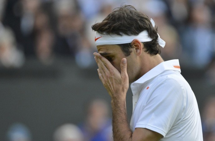 Roger Federer of Switzerland reacts during his men's singles tennis match against Sergiy Stakhovsky of Ukraine at the Wimbledon Tennis Championships, in London Roger Federer