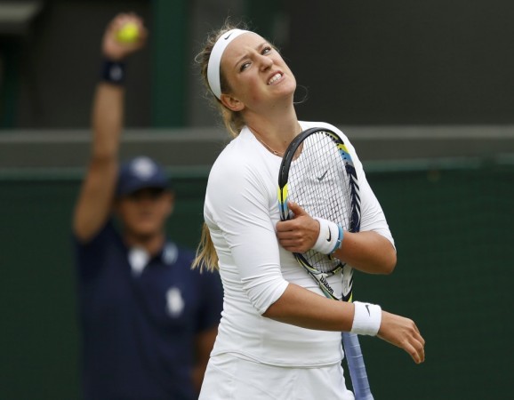 Victoria Azarenka of Belarus reacts as she has treatment on her knee after slipping and injuring herself during her women's singles tennis match against Maria Joao Koehler of Portugal at the Wimbledon Tennis Championships, in London Victoria Azarenka