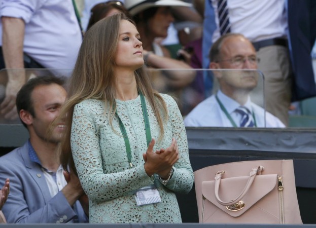 Kim Sears, the girlfriend of Andy Murray of Britain, applauds on Centre Court for the men's singles final tennis match between Murray and Novak Djokovic of Serbia at the Wimbledon Tennis Championships, in London Kim Sears