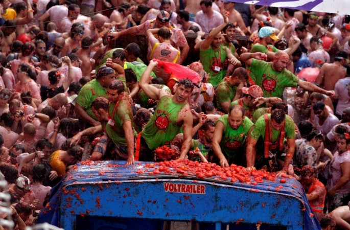 Revellers on a truck throw tomatoes into the crowd during the annual La Tomatina Festival 2013