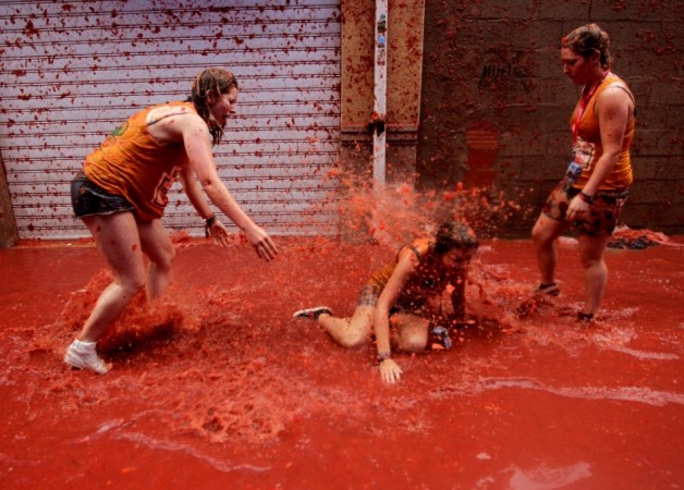 Revellers play in tomato pulp after the annual La Tomatina Festival 2013