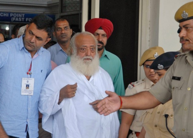Police escort spiritual leader Asaram Bapu (C) outside an airport after his arrest in Jodhpur. (Reuters)