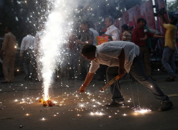 A BJP supporter lights firecrackers before Narendra Modi was crowned prime ministerial candidate for the party in New Delhi BJP supporter