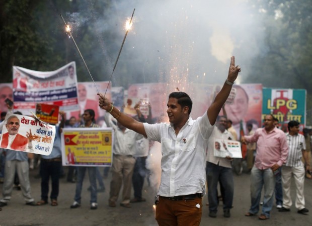 A BJP supporter lights firecrackers before Narendra Modi was crowned BJP's prime ministerial candidate in New Delhi BJP supporter